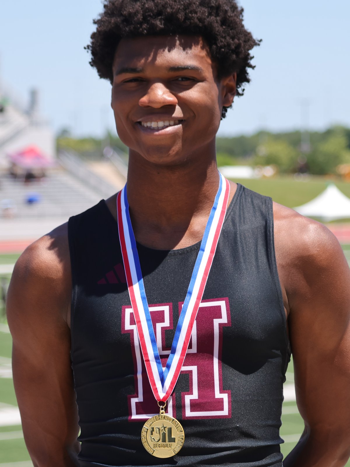 Nicholas L. Ferguson in his Houston Heights High School singlet on the track — 2026 UIL Texas 6A Boys 800m State Champion, Class of 2027 D1 recruit